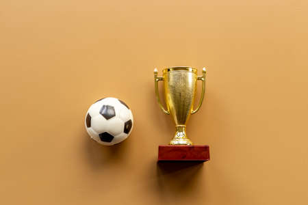 Golden trophy cup with sport game ball. Championship winner conceptの写真素材