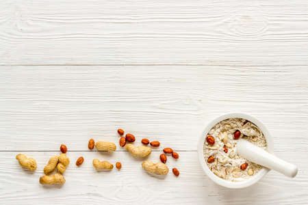 Pestle peanut flour - nuts with mortar on kitchen tableの写真素材