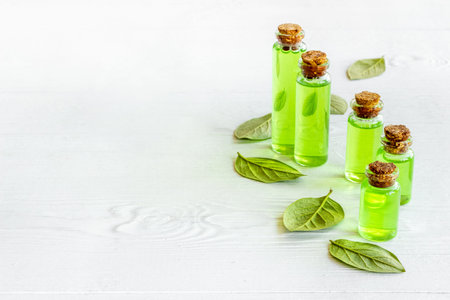 Tea tree aroma essential oil with tea salt with green leavesの写真素材