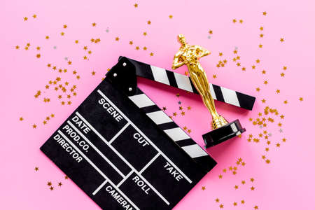 Movie clapper board with golden film award statueの写真素材