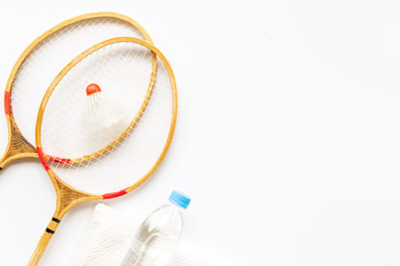 Sports equipment with badminton rackets towel and water