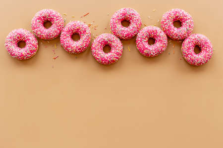 Set of pink glazed donuts with sprinkles, top viewの写真素材
