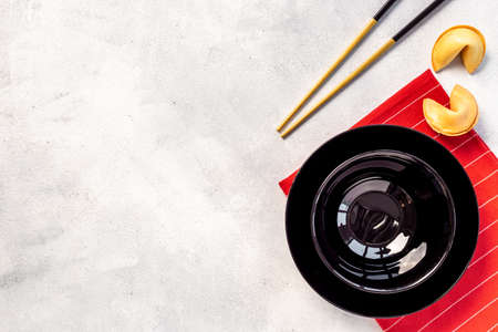 Black and gold chopsticks with red mat. Asian table place settingの写真素材