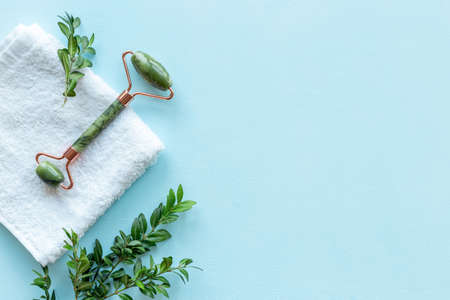 Face massage roller with green leaves for skin care lifting faceの写真素材