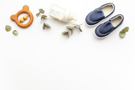 Baby newborn accessories with blue booties bootle of milk and toyの写真素材
