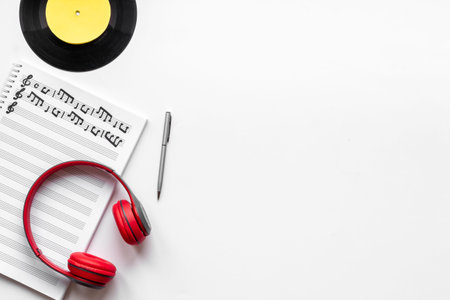 Handwritten music sheets and headphones, top view. Compose music conceptの写真素材