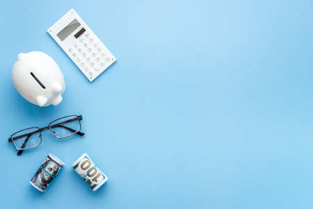 Money investments concept. Piggy bank with money and calculatorの写真素材