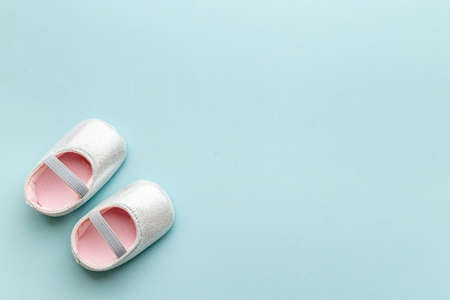 Baby girl pink newborn booties - baby shower party backgroundの写真素材