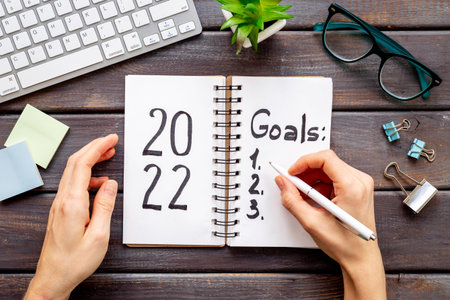 Goals hand writing list in notepad - inspirational and motivating concept