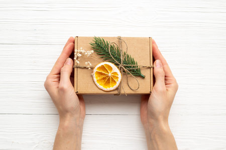 Handmade gift box in female hands. Present for Christmas