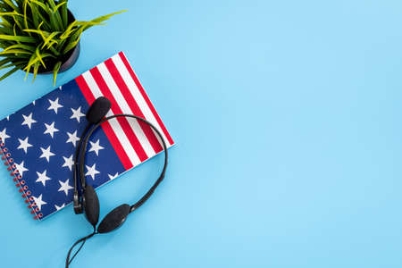 Notebook with USA flag and headphones. English lessons conceptの写真素材