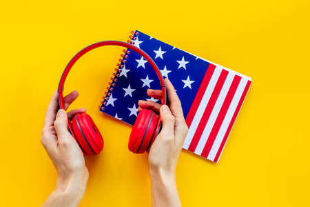 Notebook with USA flag and headphones. English lessons conceptの写真素材