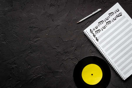 Handwritten music sheets and vinyl record, top view. Compose music conceptの写真素材