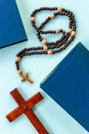 Old Bible book and rosary beads with cross. Christian religion conceptの写真素材