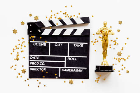 Golden movie award statue with cinema clapper boardの写真素材