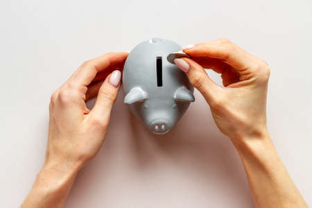 Piggy bank in hands top view. Family budget conceptの写真素材