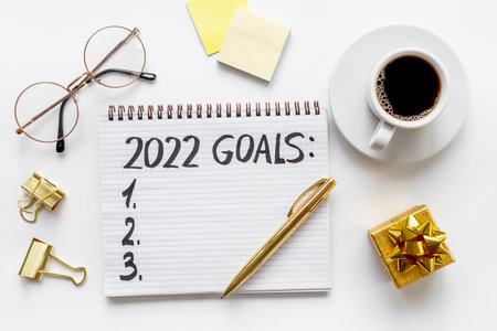 New year goals and resolutions hand writing - inspirational and motivating concept