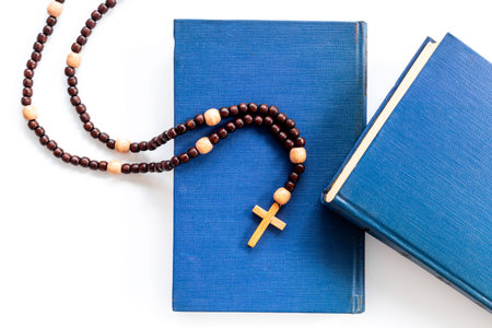 Rosary beads with cross on Bible book. Faith and prayer concept