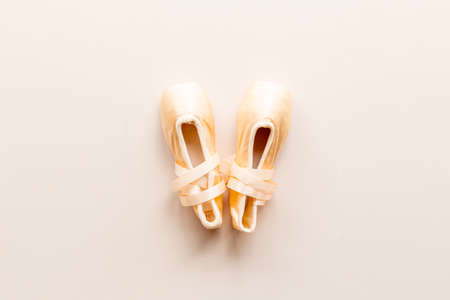 Pair of beige ballet pointe shoes with ribbon, top viewの写真素材