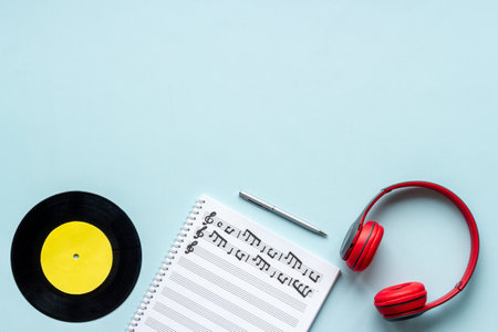Music sheets with musical notes and headphones, top viewの写真素材