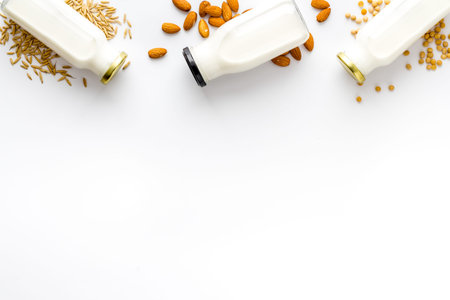 Dairy free substitute milk with nuts and cereals, top view