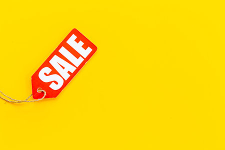 Price sale label tied with string. Discount shopping day concept.の写真素材