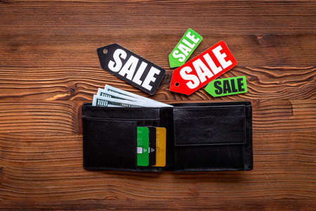 Price sale label and wallet with banknotes and bank cardsの写真素材