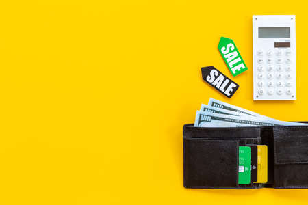 Sale tag and wallet with banknotes and bank cardsの写真素材