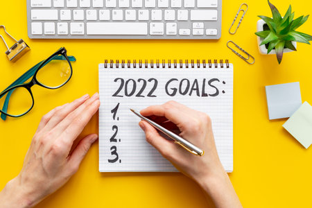 Goals hand writing list in notepad - inspirational and motivating concept