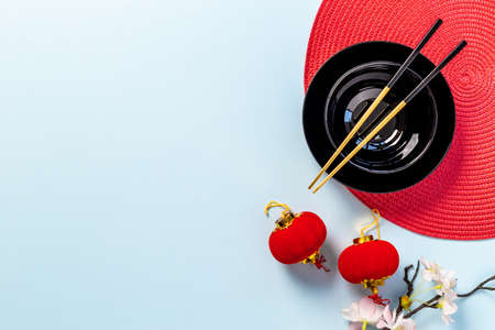 Black and gold chopsticks with red mat. Asian tabble place settingの写真素材