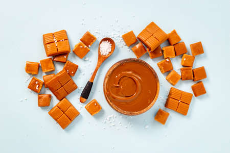 Melt caramel sauce in bowl awith toffee candies, top view