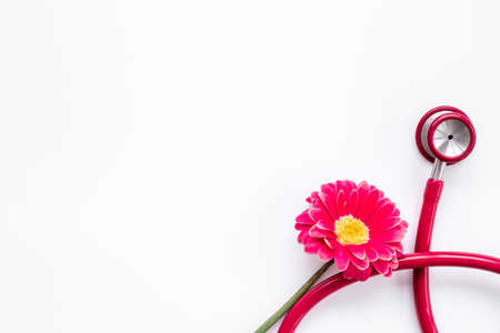Women health background with red stethoscope and flowerの写真素材