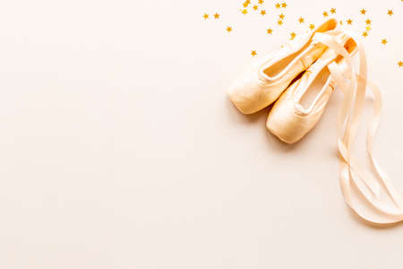Pair of beige ballet pointe shoes with ribbon, top viewの写真素材