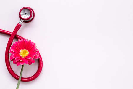 Women health background with red stethoscope and flowerの写真素材