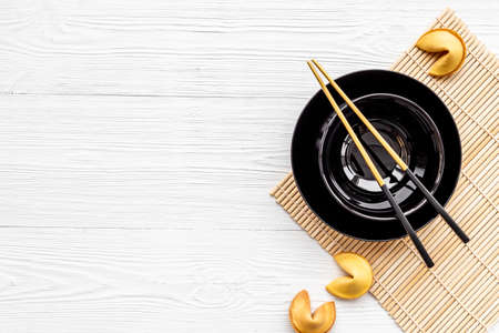 Asian style tabble place setting with fortune cookies and golden chopsticksの写真素材