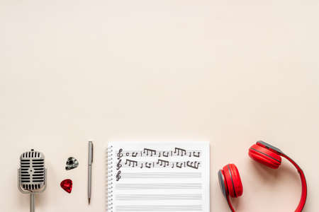 Handwritten music sheets and headphones, top view. Compose music conceptの写真素材
