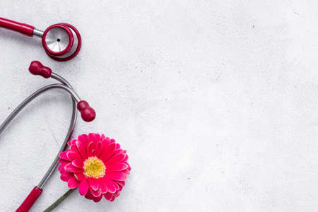 Breast cancer diagnosis with red stethoscope and flowerの写真素材