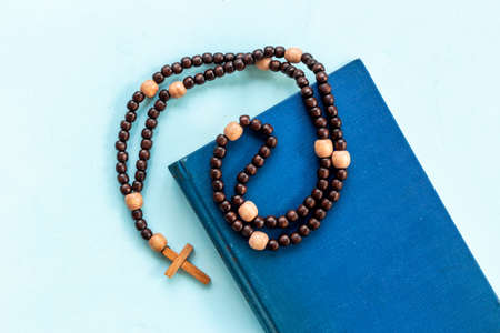 Old Bible book and rosary beads with cross. Christian religion conceptの写真素材
