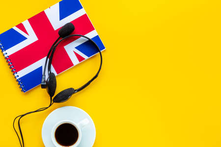 Notebook with British flag and headphones. English lessons conceptの写真素材