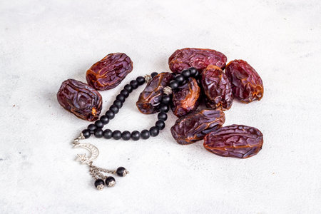 Ramadan Kareem background. Dates fruits and rosary with star and crescentの写真素材