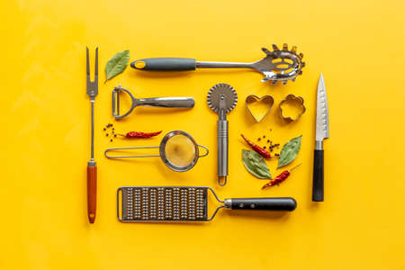 Flat lay of metal kitchen utensils and cookware