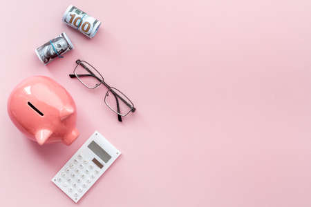 Money investments concept. Piggy bank with money and calculatorの写真素材