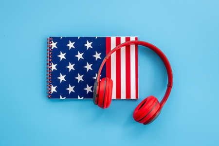 USA flag on notebook with headphones. E-learning language concept.の写真素材