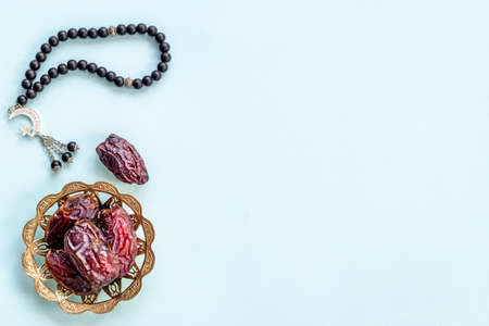 Ramadan concept. Black Islamic rosary with star and crescent with dates fruitsの写真素材