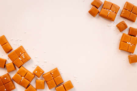 Frame of toffee caramel candies with sea salt, top viewの写真素材