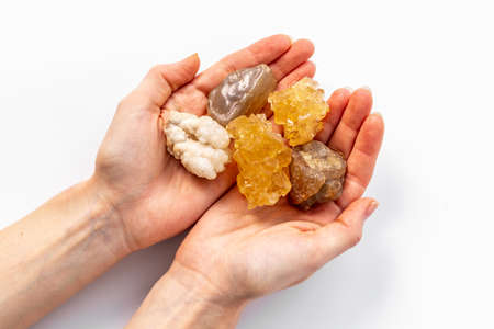 Natural crystal mineral stone in hands. Crystal texture closeup