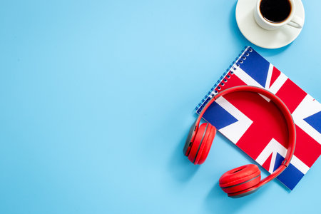 Notebook with British flag and headphones. English lessons conceptの写真素材