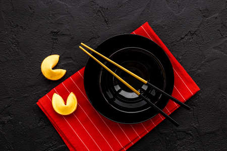 Fortune cookies and golden chopsticks. Asian style table settingの写真素材