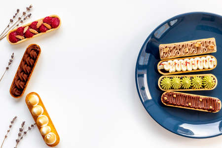 Set of french dessert eclairs with colorful topping