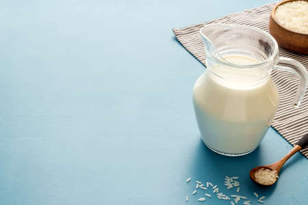 Non dairy vegan milk in glass jar with ingredients, close upの写真素材